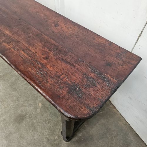 fig 1. An antique dark fruitwood console table featuring a single central drawer, straight legs, and an H-stretcher base.