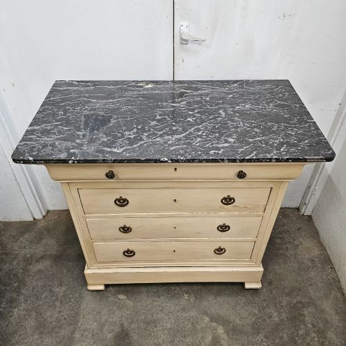 fig 1. An off-white painted Louis Philippe chest of drawers with a dark marble top and brass ring handles.