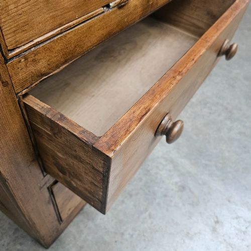 fig 1. A Victorian waxed pine bank of six drawers arranged in two columns with round turned wooden knobs and a plain plinth base.