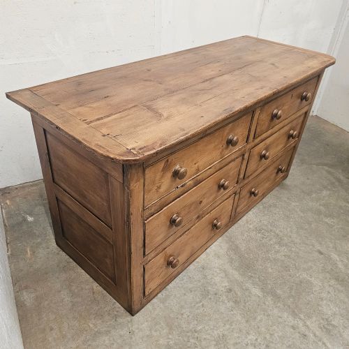 fig 2. A Victorian waxed pine bank of six drawers arranged in two columns with round turned wooden knobs and a plain plinth base.
