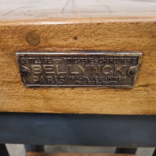 fig 2. A small antique French butchers block featuring an end-grain beech top with a brass makers plate set on a dark painted wooden stand with a lower shelf.