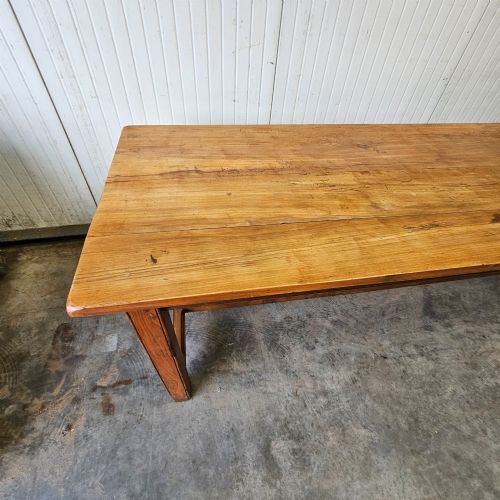 fig 2. A long French country dining table crafted from beech and elm timber with a plank top and an H-stretcher base.
