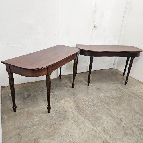 fig 1. A pair of English mahogany console tables featuring D-shaped tops, subtle reeded aprons, and slender fluted tapered legs.