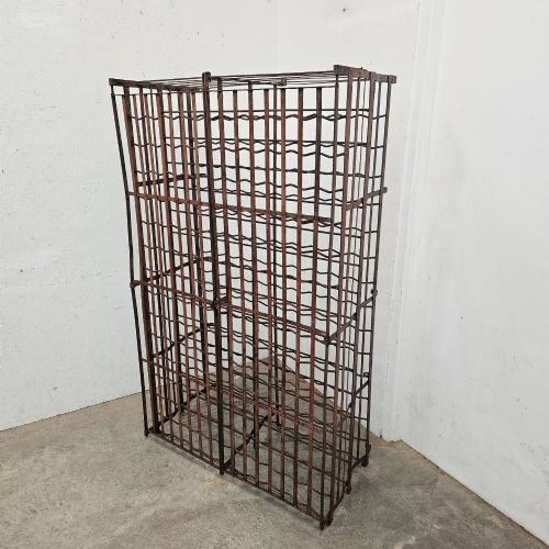 fig 1. A large freestanding French steel wine rack featuring a open lattice riveted frame with multiple horizontal bottle tiers.