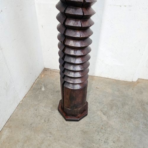 fig 1. A tall hand-carved dark walnut wooden wine press screw with a continuous spiral thread.