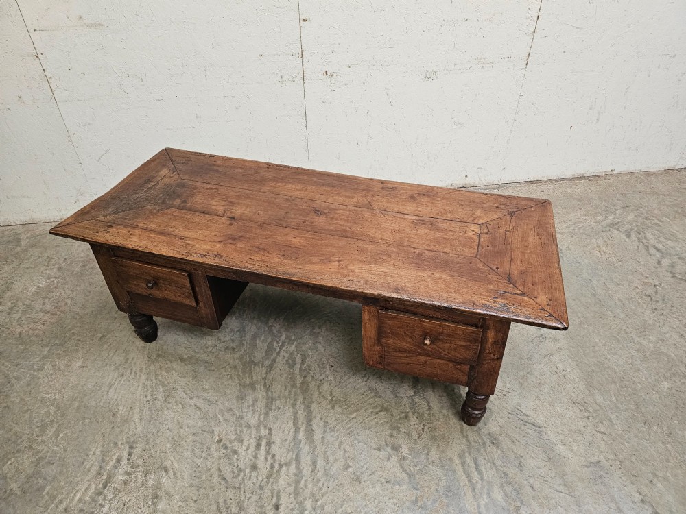 A low French fruitwood coffee table featuring three carved recessed front panels, side handles, and turned support feet. View II
