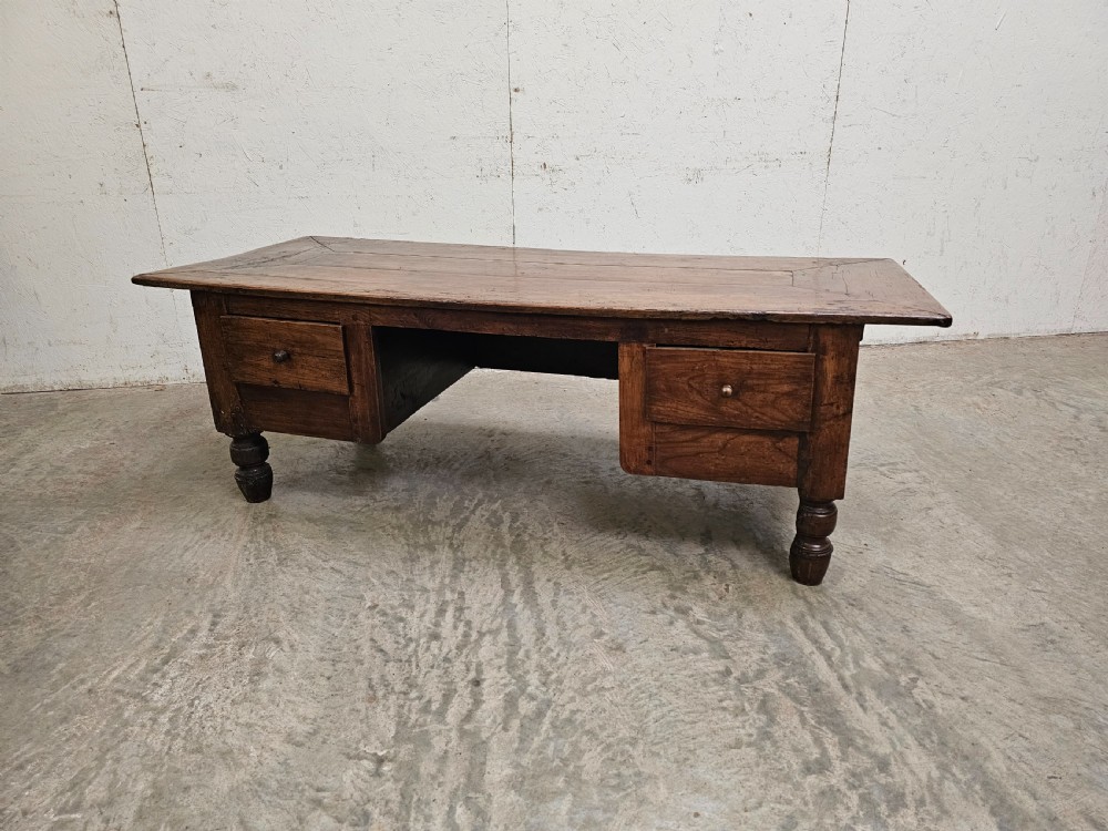 A low French fruitwood coffee table featuring three carved recessed front panels, side handles, and turned support feet. View III