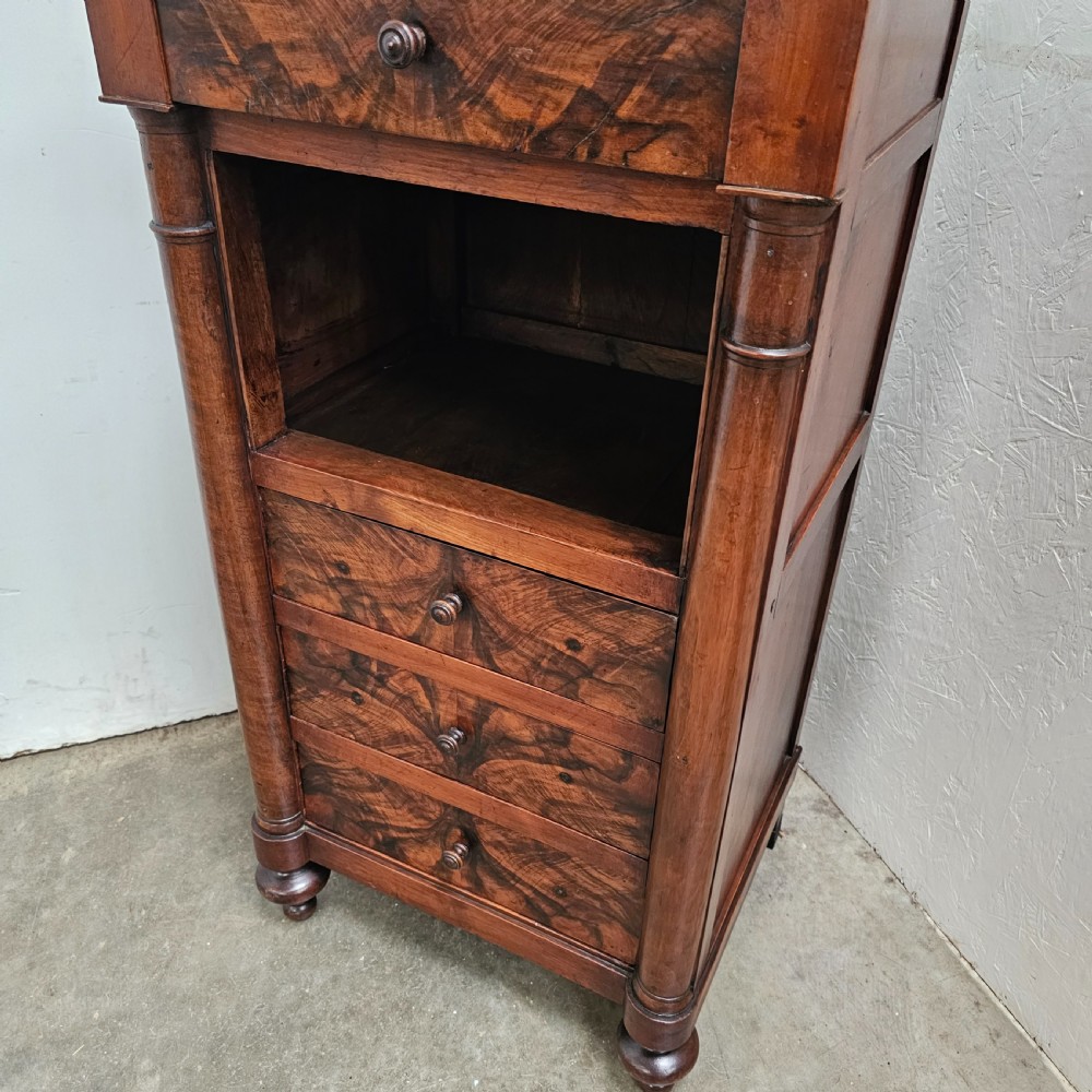 A French 19th-century figured walnut nightstand with a grey variegated marble top, featuring an open shelf above three lower drawers. View II