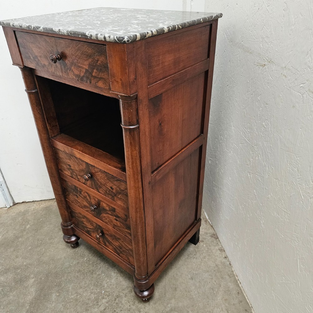 A French 19th-century figured walnut nightstand with a grey variegated marble top, featuring an open shelf above three lower drawers. View III