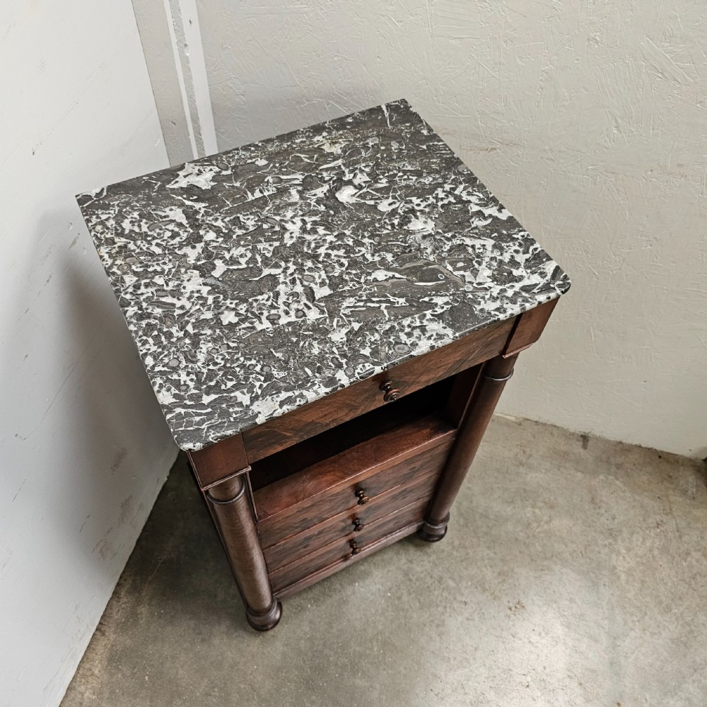 A French 19th-century figured walnut nightstand with a grey variegated marble top, featuring an open shelf above three lower drawers. View VI