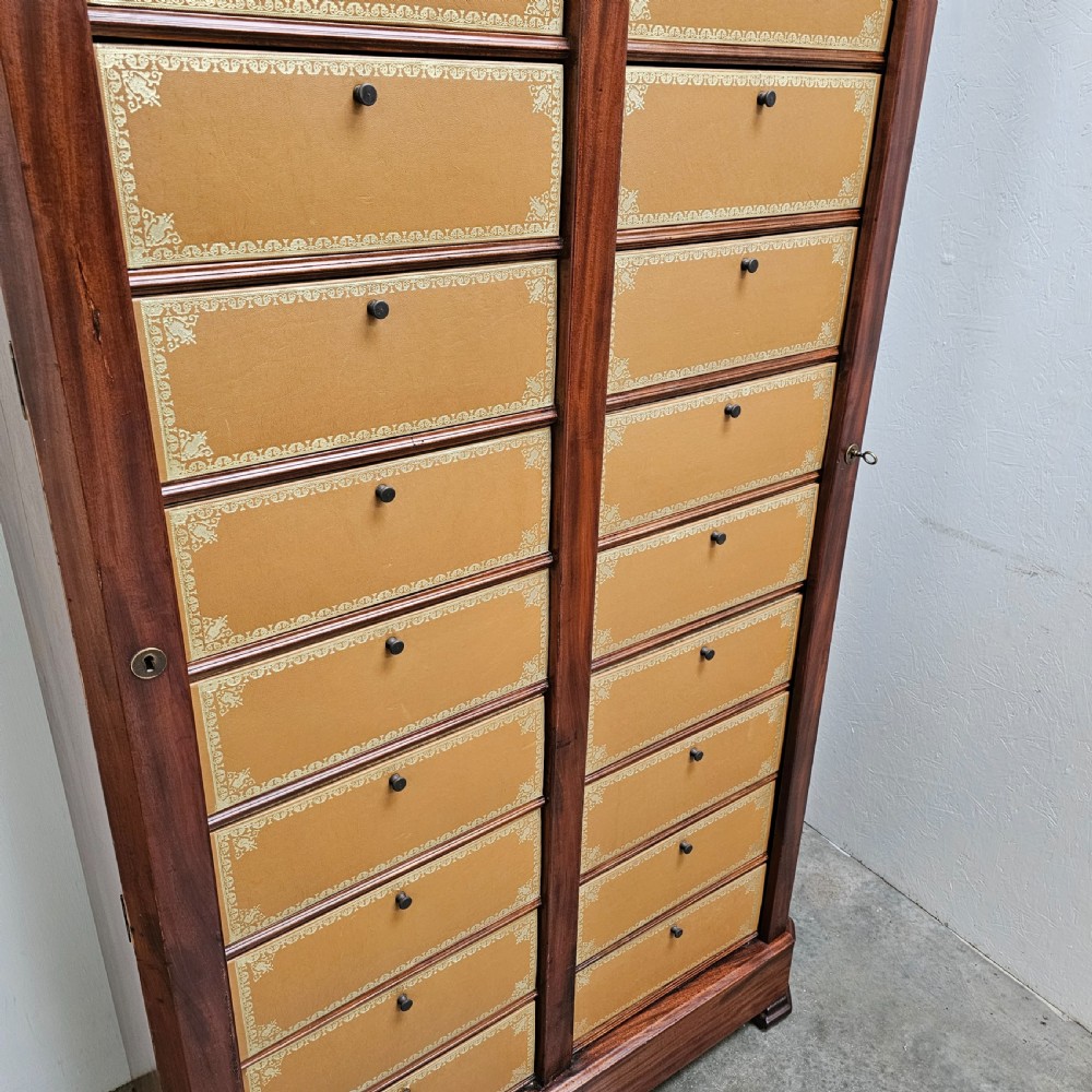 A tall French mahogany cartonnier cabinet with two vertical columns of drop-front drawers featuring gilt-tooled tan leather fronts. View II