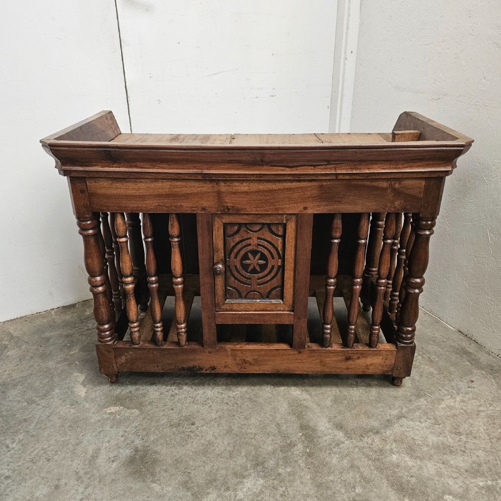 A 19th-century French provincial carved walnut panetiere featuring turned spindle balusters, a slatted base, and a central cupboard door carved with a geometric star motif. View II