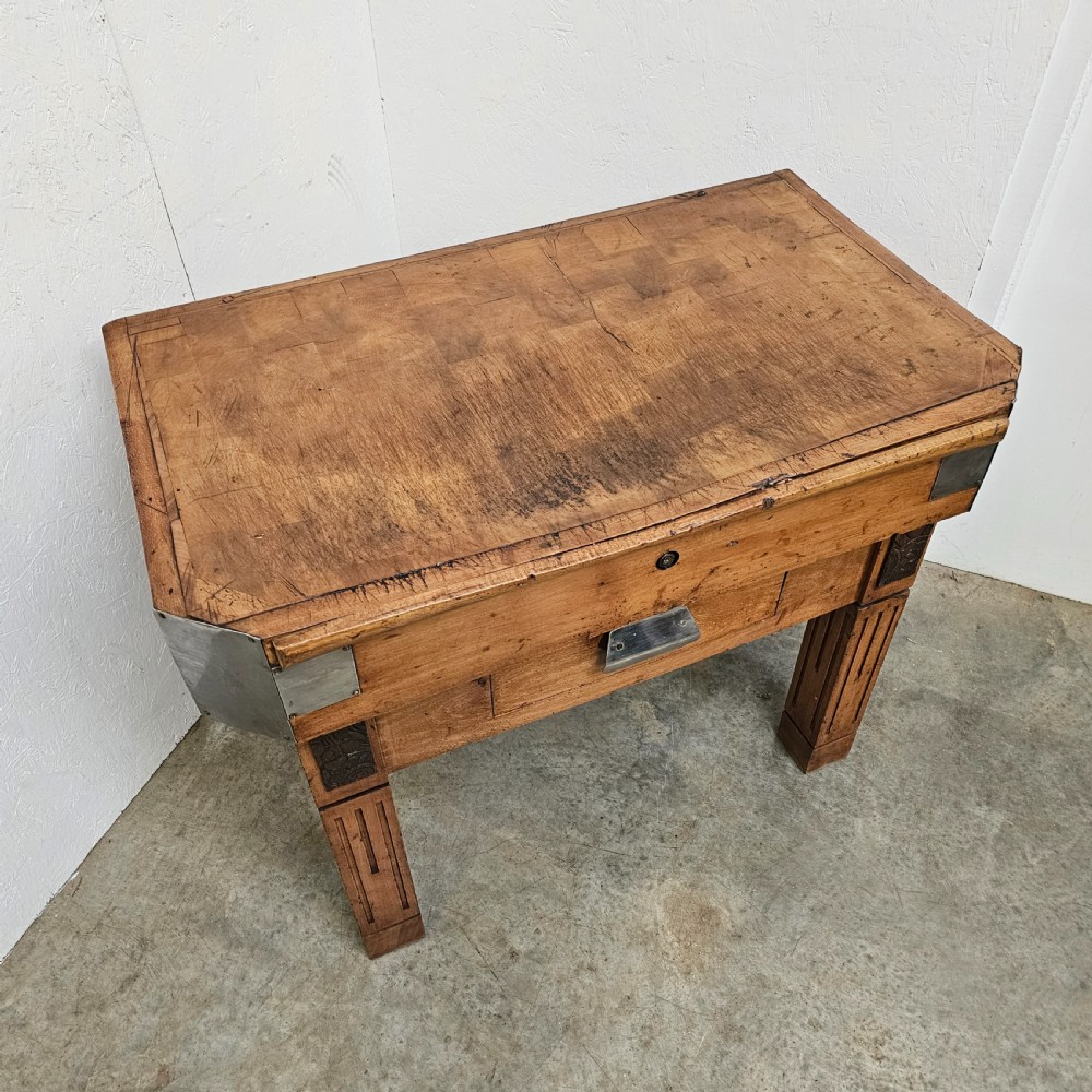 An antique French beech butchers block featuring a dished top surface, metal corner brackets, a single drawer, and carved square legs. View II