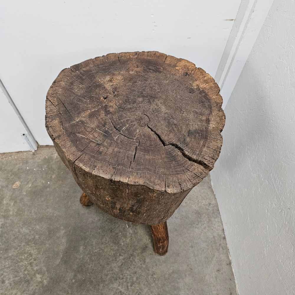 A rustic 19th-century French oak game block featuring a thick solid timber section supported by three splayed wooden legs. View IV