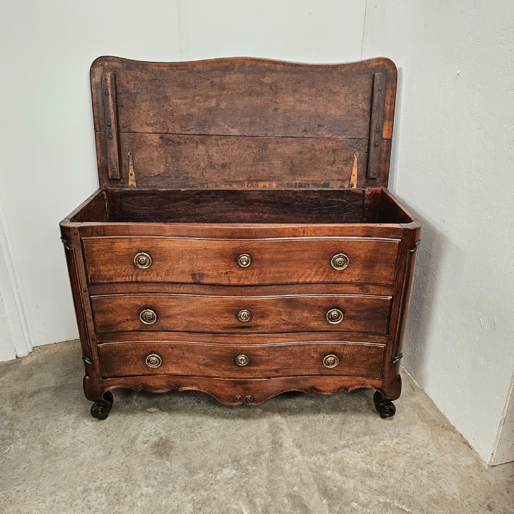 A nineteenth-century French serpentine wood commode featuring three drawers with brass ring handles and carved cabriole legs. View II