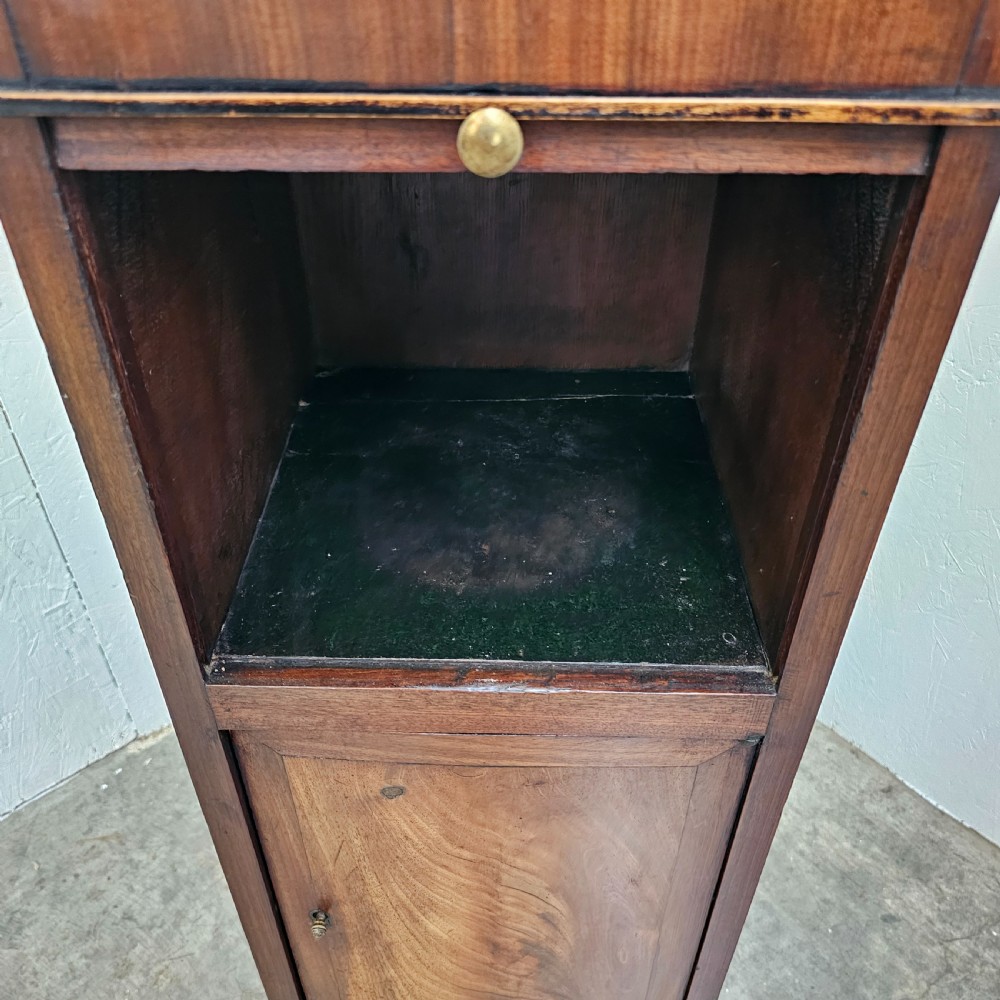 A tall, narrow 19th-century French mahogany nightstand featuring an inset marble top, a sliding tambour door section, and a lower single cupboard door. View V