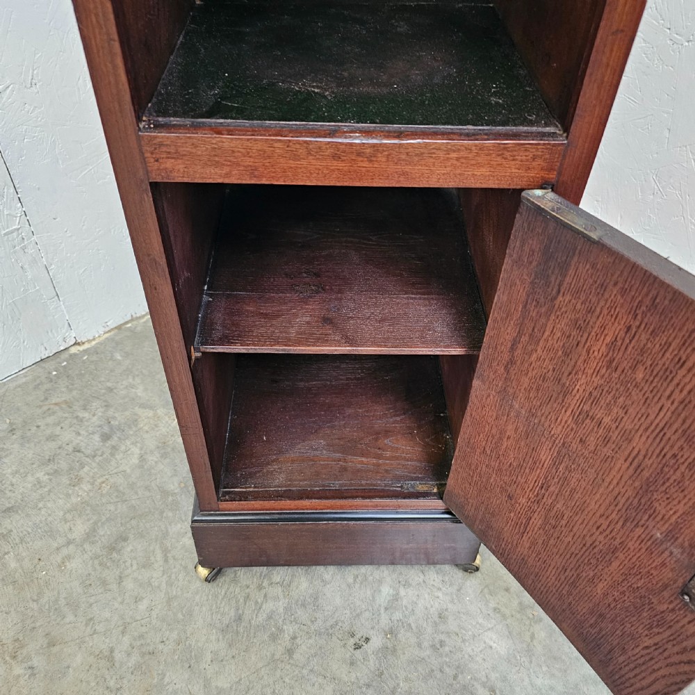 A tall, narrow 19th-century French mahogany nightstand featuring an inset marble top, a sliding tambour door section, and a lower single cupboard door. View VI