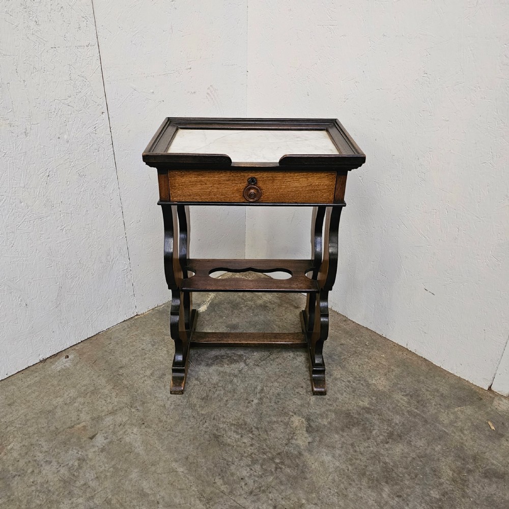 A French 19th-century walnut and ebonised stand featuring an inset marble top, a single frieze drawer, shaped supports, and a lower shelf. View II
