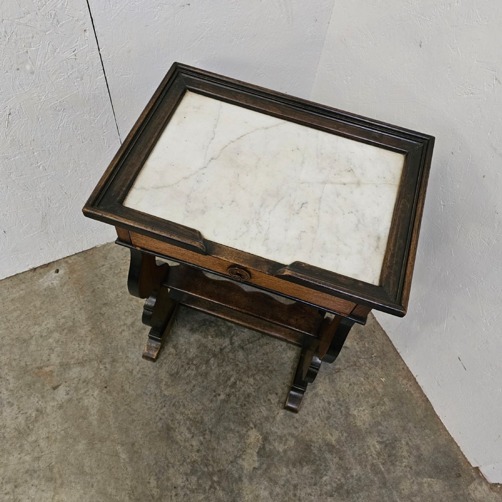 A French 19th-century walnut and ebonised stand featuring an inset marble top, a single frieze drawer, shaped supports, and a lower shelf. View III