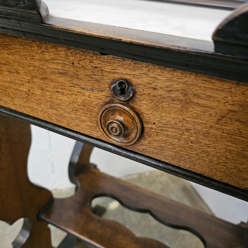 A French 19th-century walnut and ebonised stand featuring an inset marble top, a single frieze drawer, shaped supports, and a lower shelf. View IV