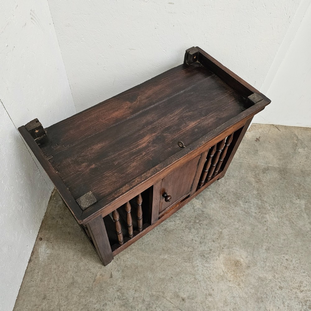 A 19th-century French provincial walnut panetiere with turned spindle sides, a central solid door, and a rich dark finish. View III