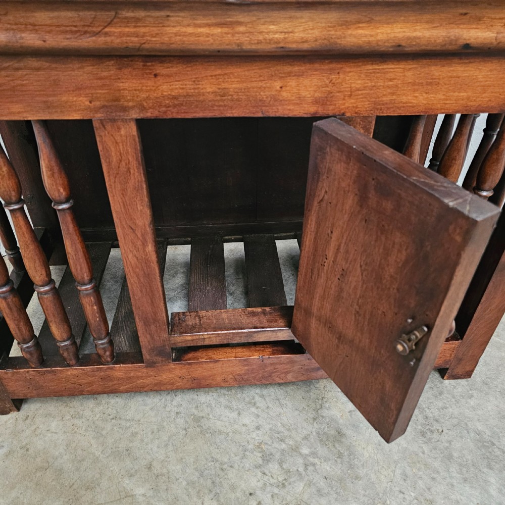 A 19th-century French provincial walnut panetiere with turned spindle sides, a central solid door, and a rich dark finish. View IV