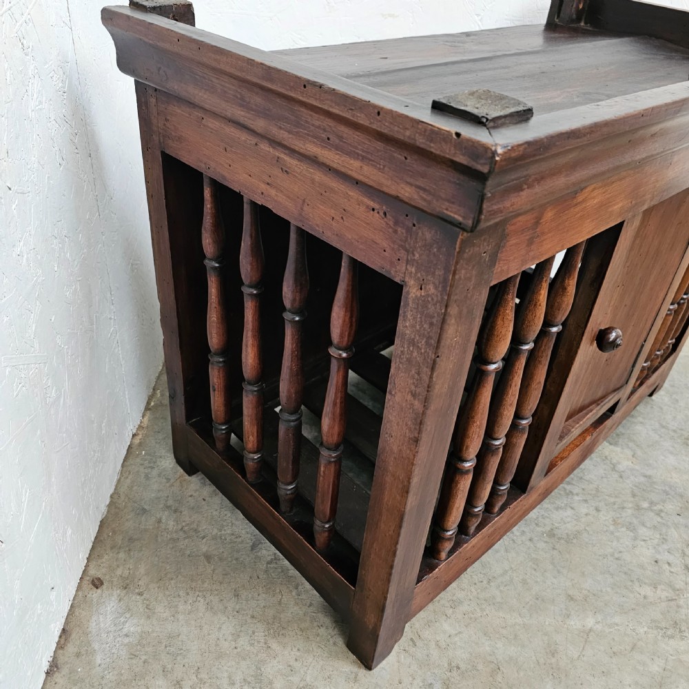 A 19th-century French provincial walnut panetiere with turned spindle sides, a central solid door, and a rich dark finish. View V