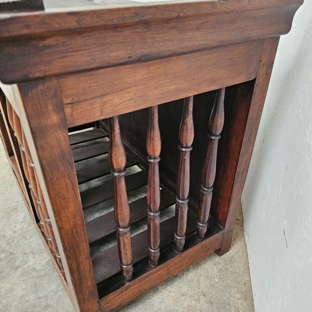 A 19th-century French provincial walnut panetiere with turned spindle sides, a central solid door, and a rich dark finish. View VI