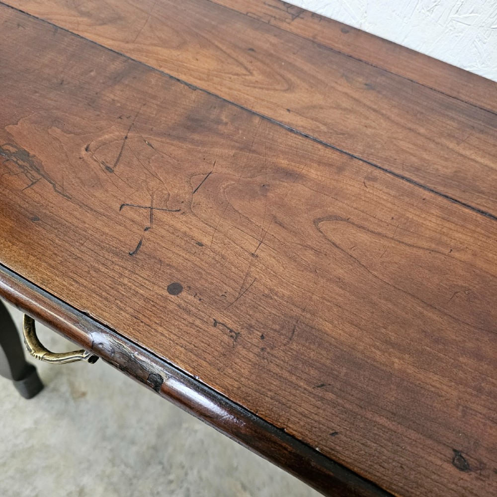 A French cherrywood console table featuring twin front drawers with decorative brass handles, a shaped apron, and front cabriole legs. View V