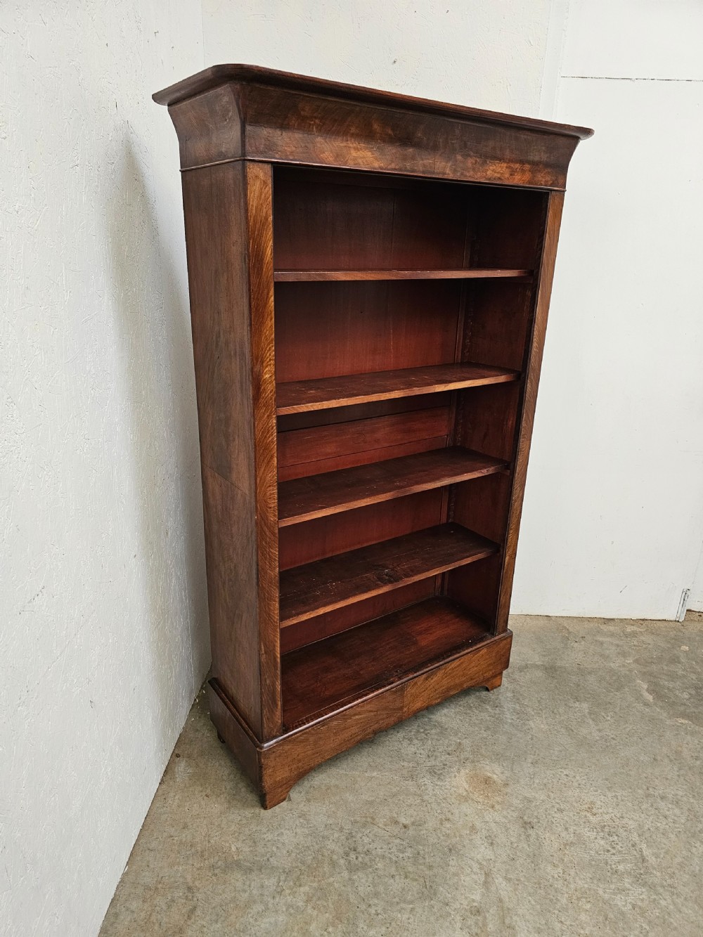 A 19th-century French open bookcase crafted from warm brown walnut wood featuring five adjustable shelves and a classic plinth base. View II