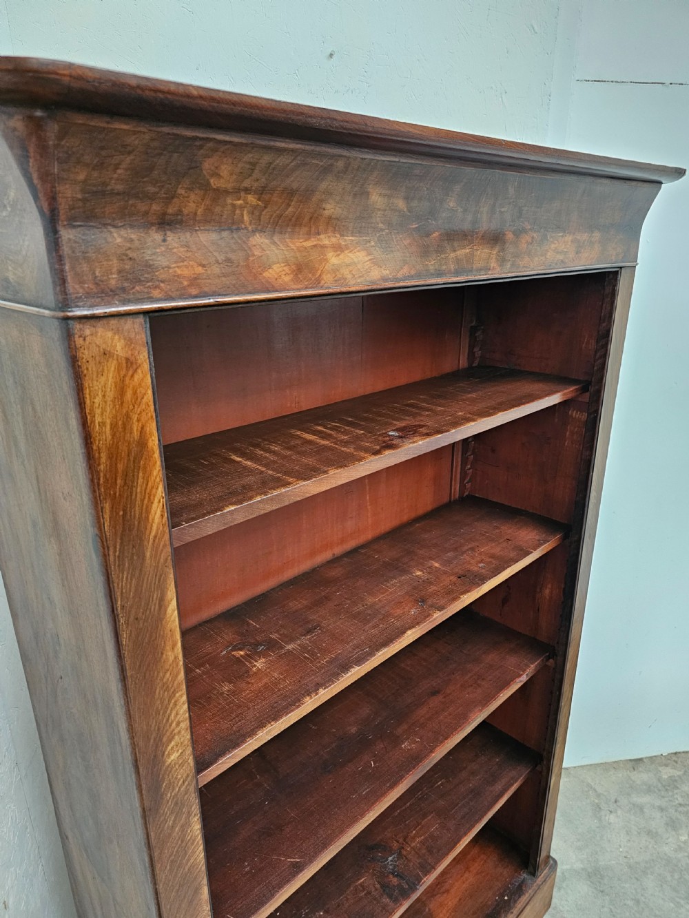 A 19th-century French open bookcase crafted from warm brown walnut wood featuring five adjustable shelves and a classic plinth base. View III