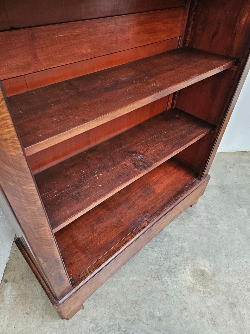 A 19th-century French open bookcase crafted from warm brown walnut wood featuring five adjustable shelves and a classic plinth base. View IV