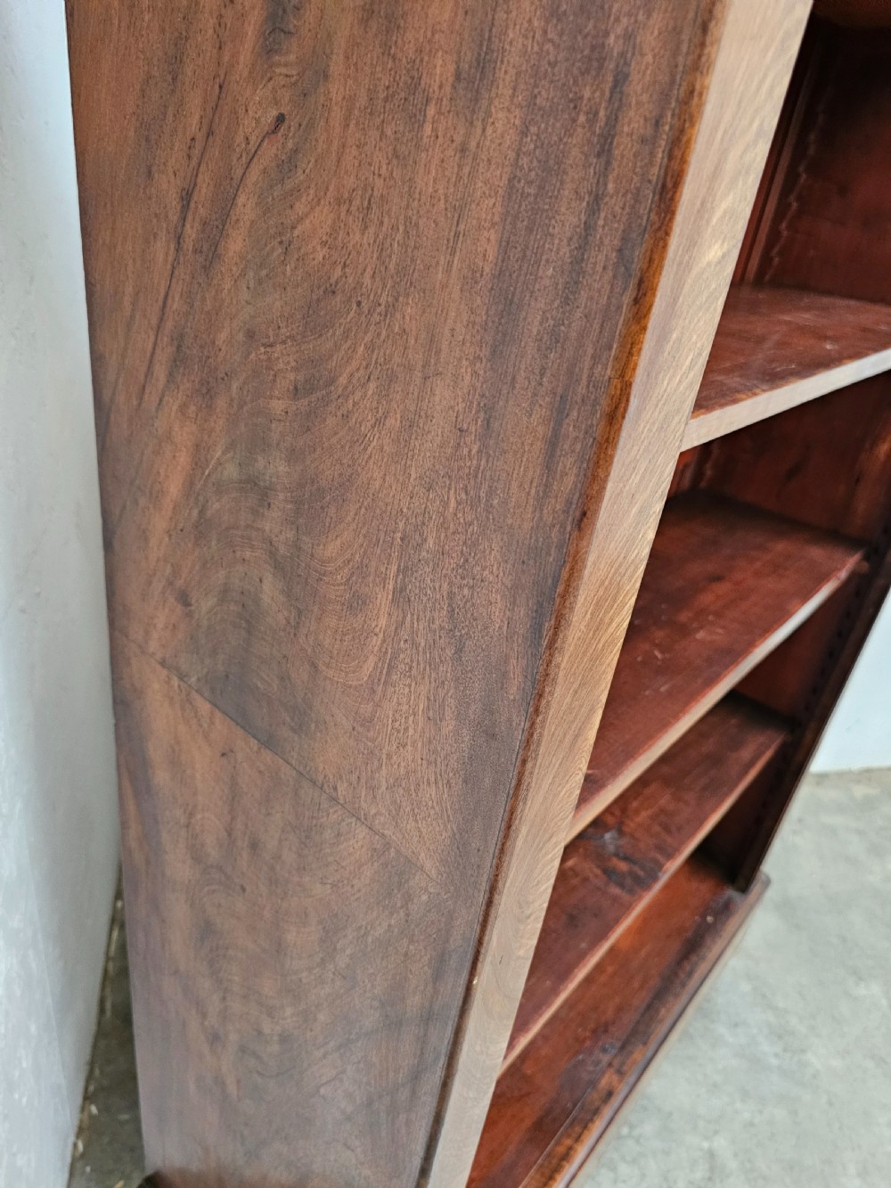 A 19th-century French open bookcase crafted from warm brown walnut wood featuring five adjustable shelves and a classic plinth base. View V