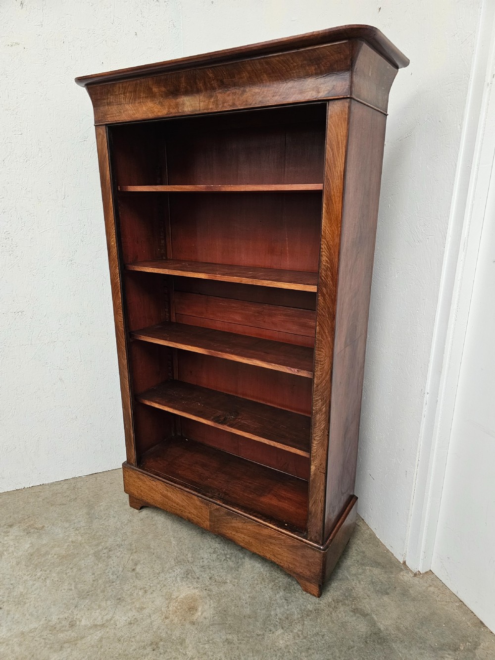 A 19th-century French open bookcase crafted from warm brown walnut wood featuring five adjustable shelves and a classic plinth base. View VIII
