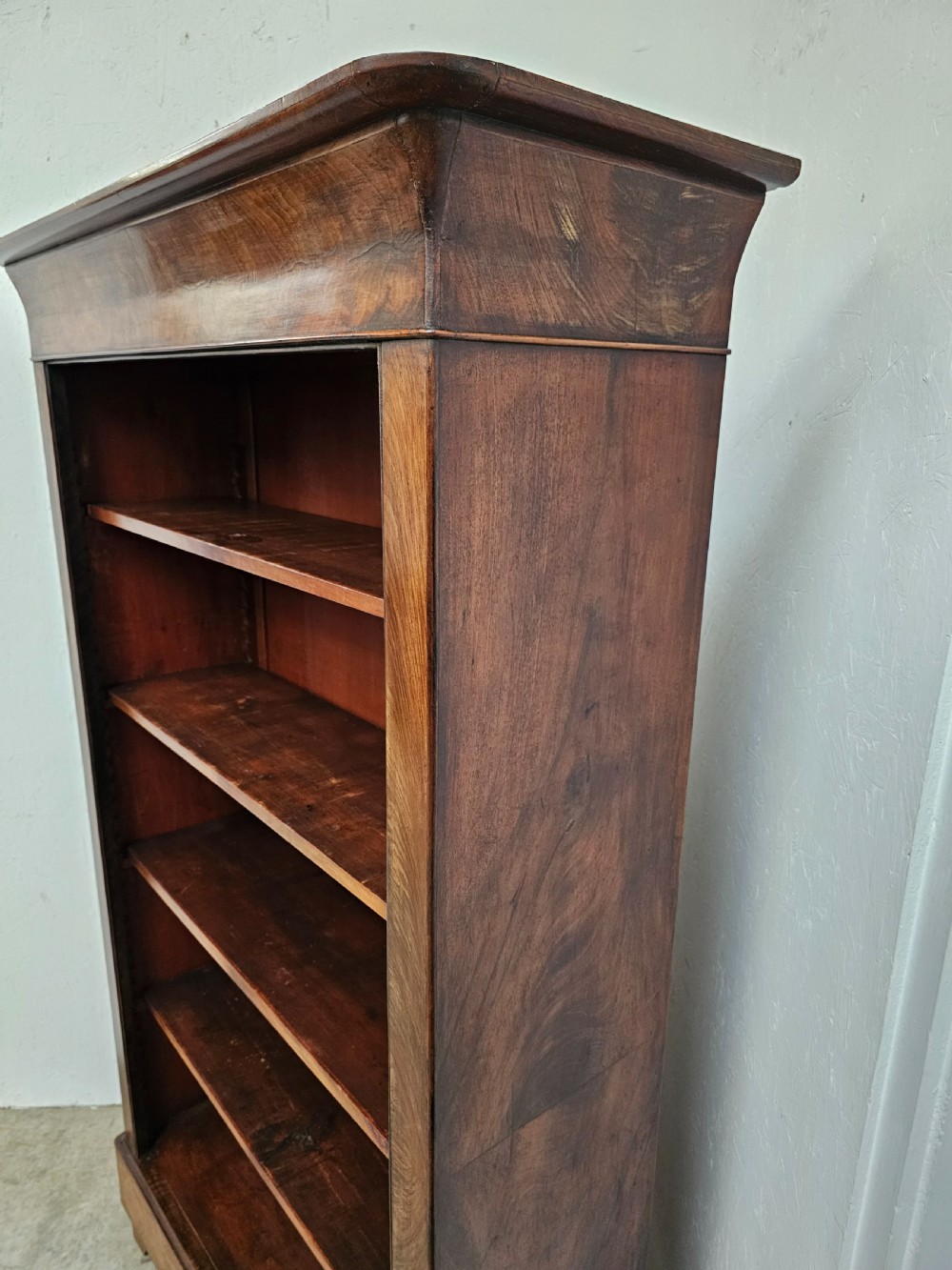 A 19th-century French open bookcase crafted from warm brown walnut wood featuring five adjustable shelves and a classic plinth base. View IX