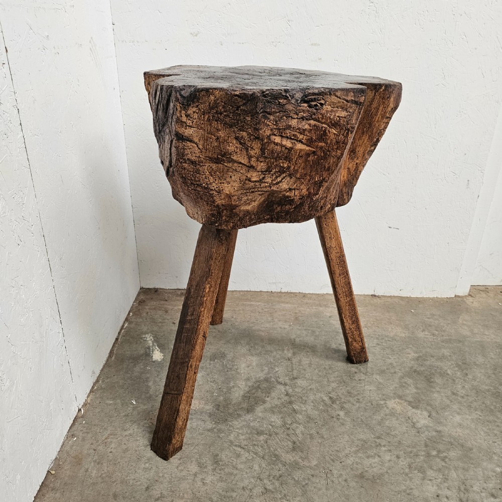 A rustic French oak game block made from a thick tree trunk section set upon three splayed wooden legs. View II