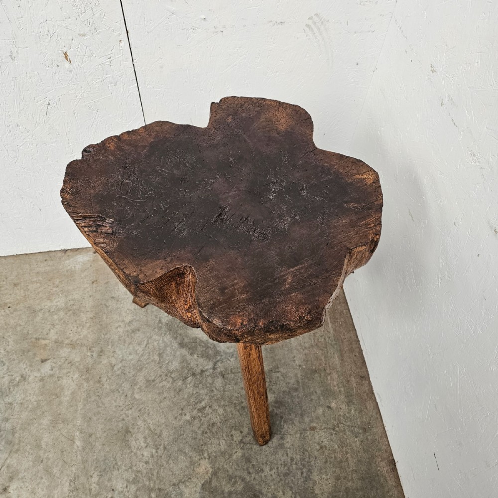 A rustic French oak game block made from a thick tree trunk section set upon three splayed wooden legs. View IV