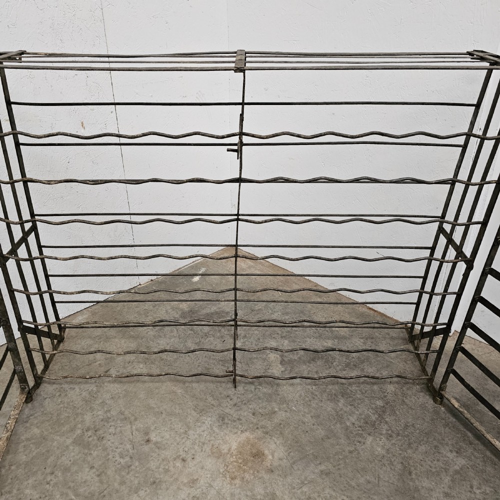 A large French dark iron lockable wine cage with double doors and horizontal bottle slots designed to hold 96 bottles. View IV