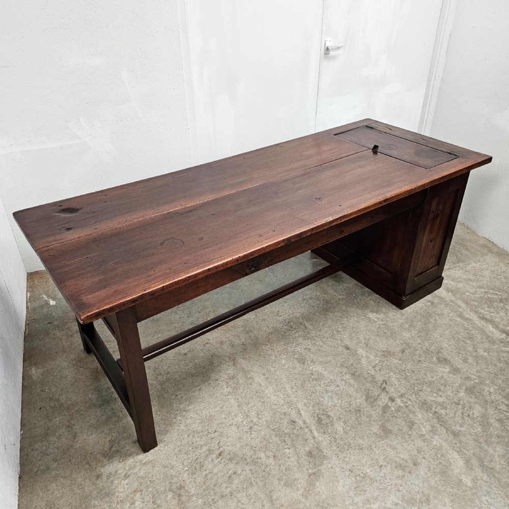 An antique French dark walnut bread prep table featuring a two-board top, side pedestal storage compartment, and lower stretcher base. View II