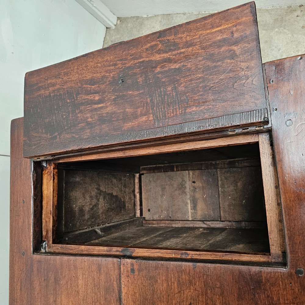 An antique French dark walnut bread prep table featuring a two-board top, side pedestal storage compartment, and lower stretcher base. View IV