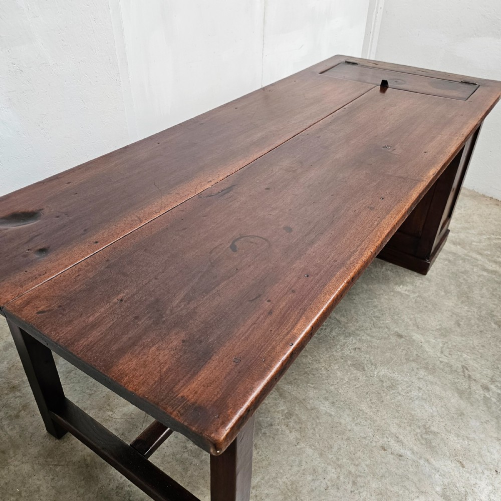 An antique French dark walnut bread prep table featuring a two-board top, side pedestal storage compartment, and lower stretcher base. View IX