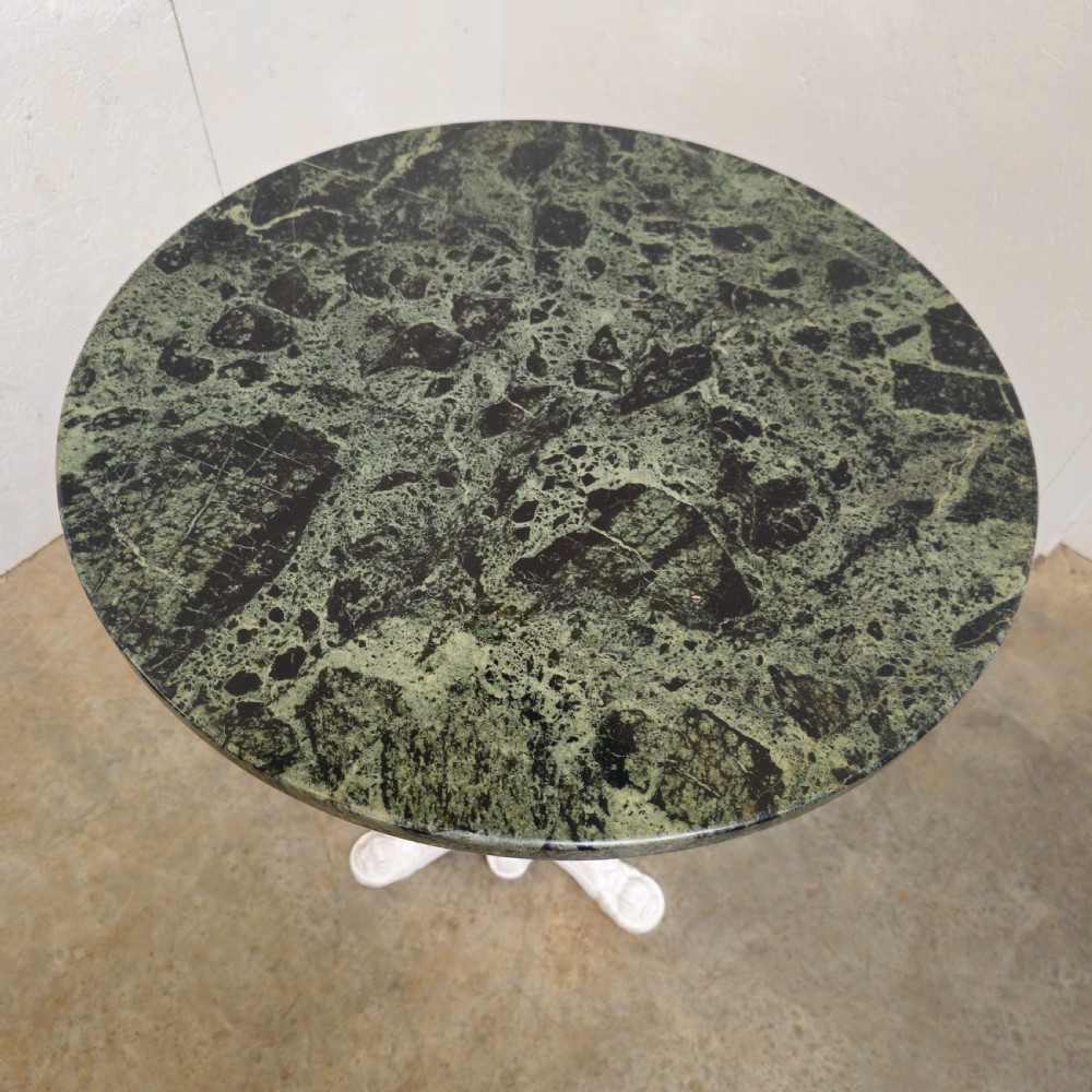 A circular green marble bistro table featuring a white painted cast iron pedestal stem with three decorative feet. View IV