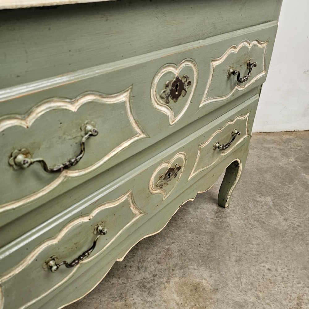 An 18th-century French provincial painted commode featuring two long drawers finished in muted green paint with cream trim and metal handles. View III