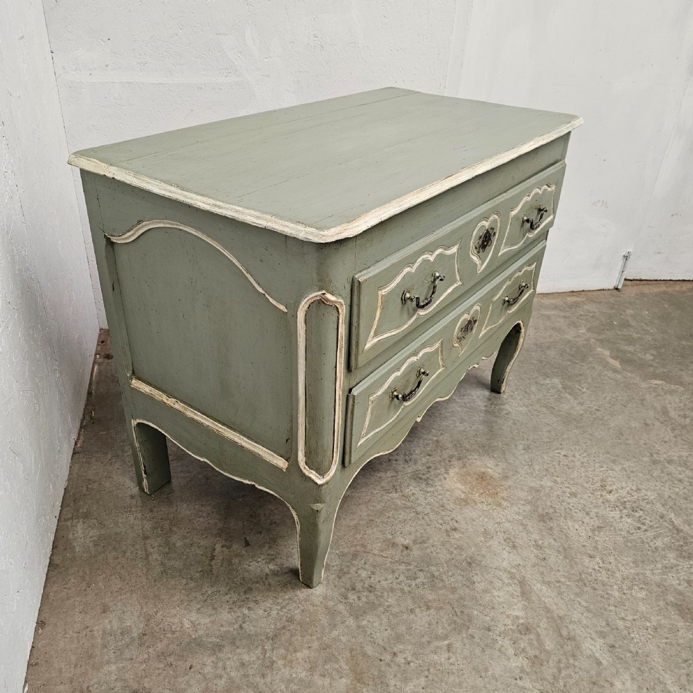 An 18th-century French provincial painted commode featuring two long drawers finished in muted green paint with cream trim and metal handles. View VI