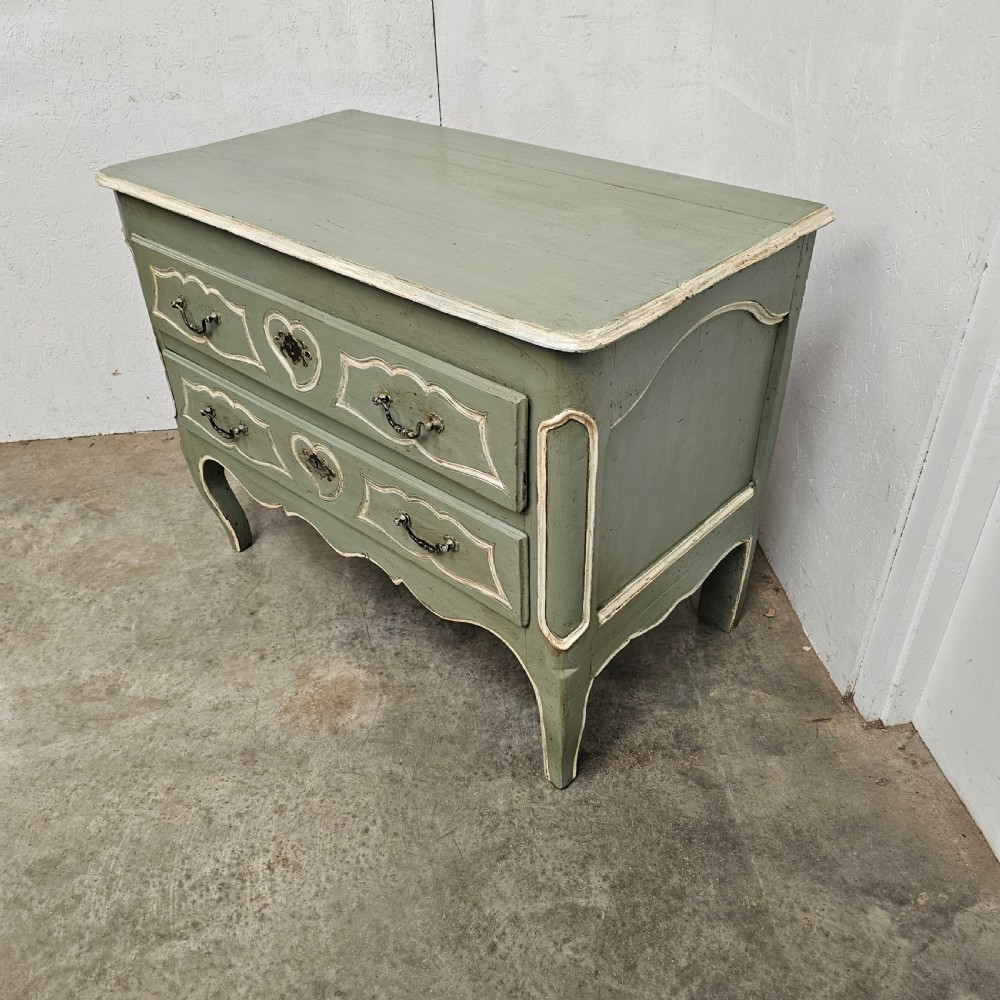 An 18th-century French provincial painted commode featuring two long drawers finished in muted green paint with cream trim and metal handles. View VII