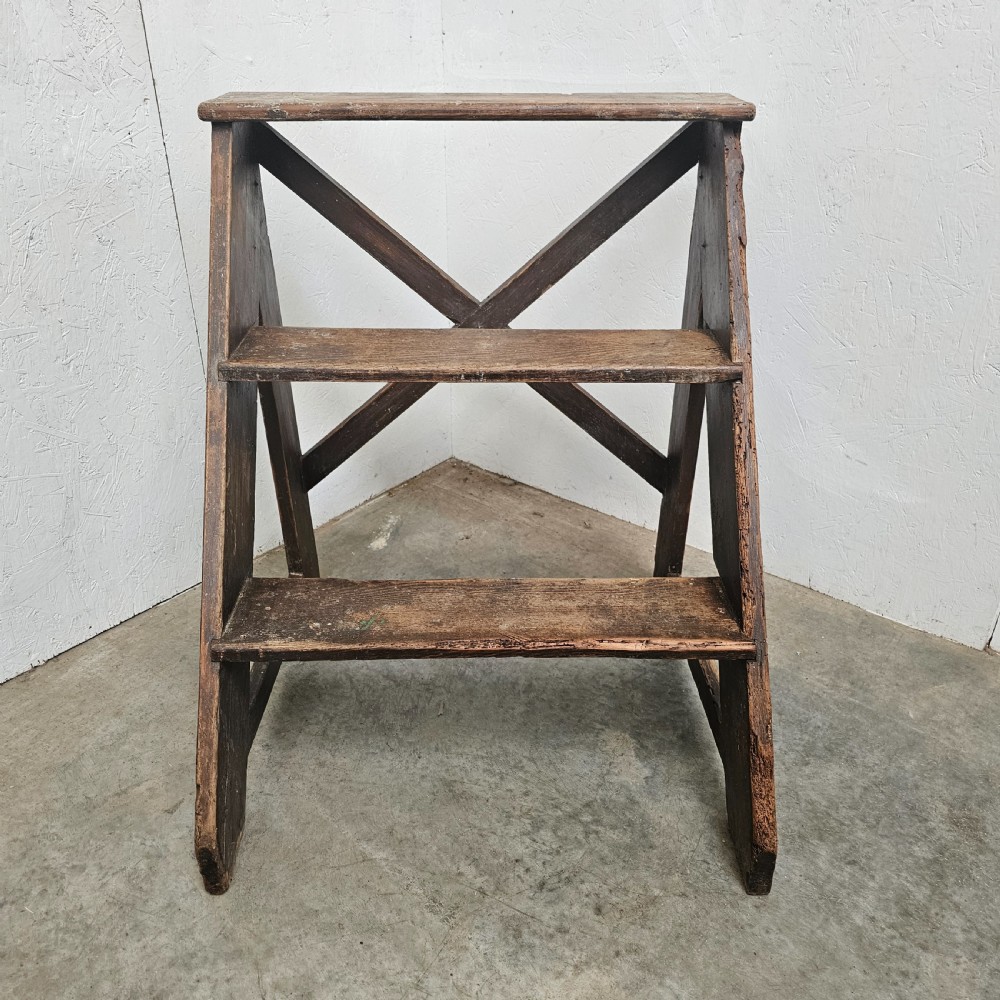 A three-tier dark pine wooden step stool featuring an A-frame structure with a cross-brace on the reverse.