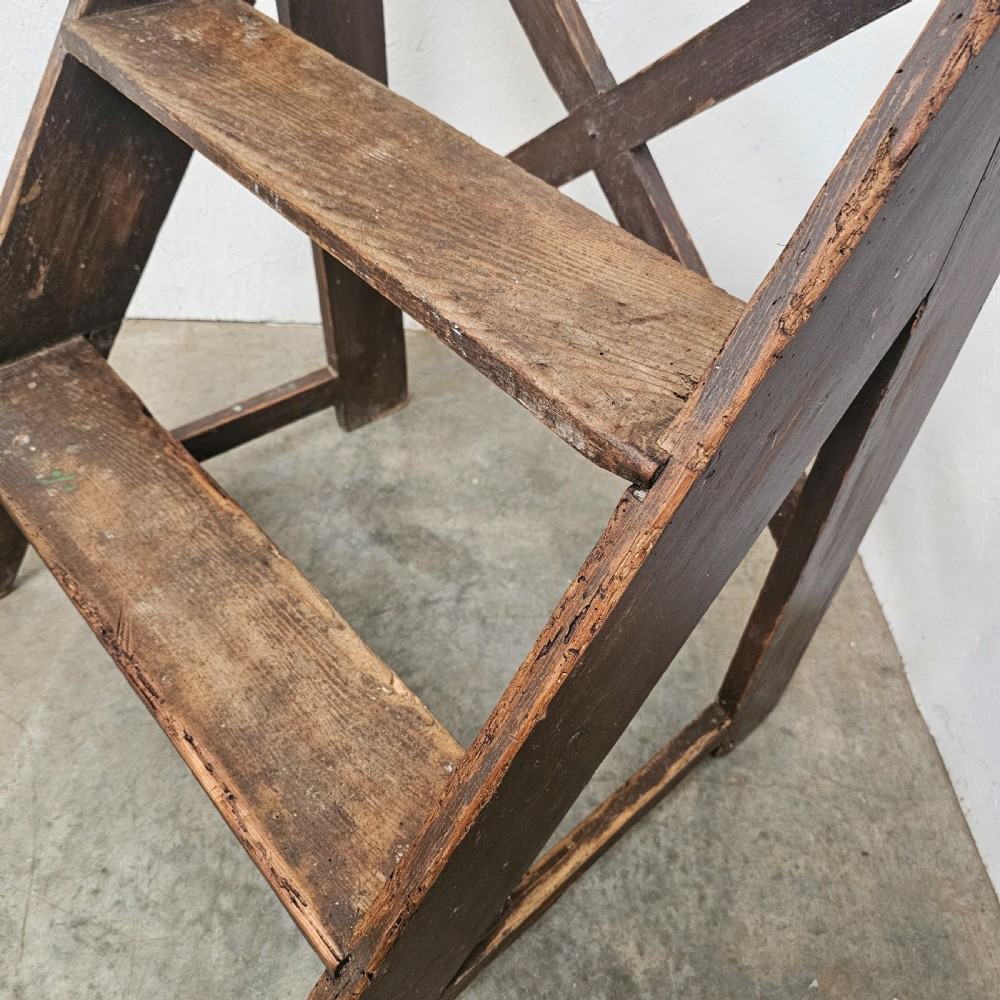 A three-tier dark pine wooden step stool featuring an A-frame structure with a cross-brace on the reverse. View V