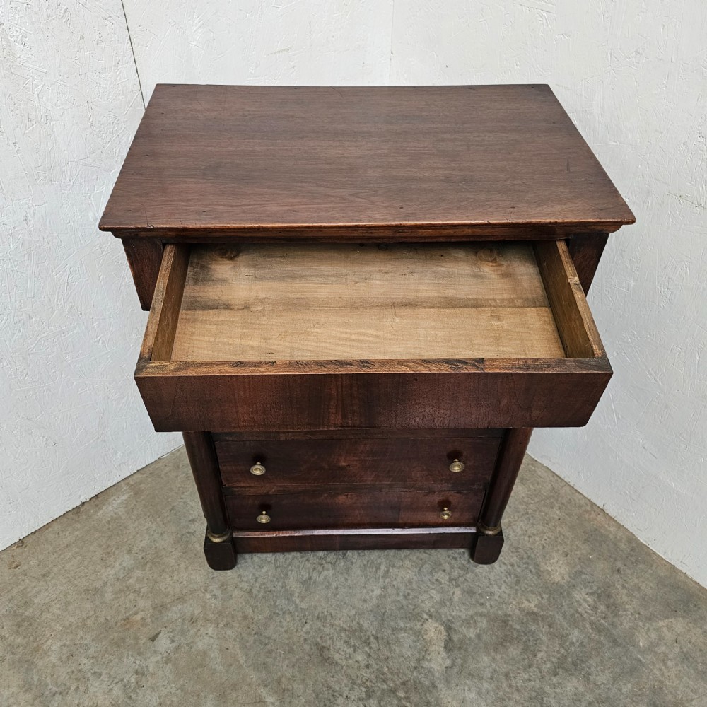 A five-drawer French Empire style mahogany chest featuring brass knobs and flanking pilaster columns. View III