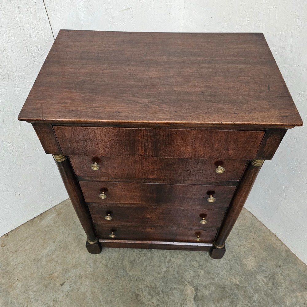 A five-drawer French Empire style mahogany chest featuring brass knobs and flanking pilaster columns. View VII