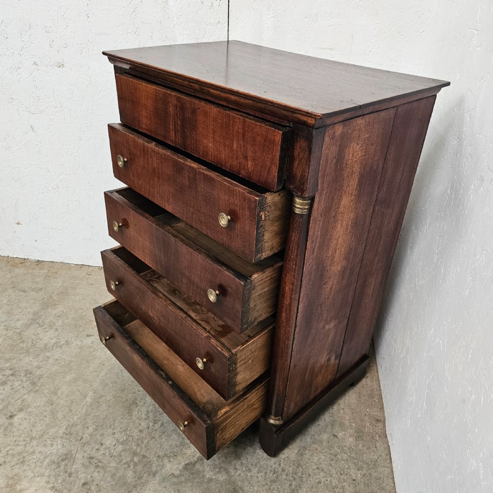 A five-drawer French Empire style mahogany chest featuring brass knobs and flanking pilaster columns. View VIII